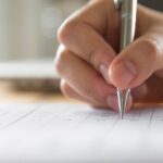 hand-writing-paper-with-pen-1-1024x643